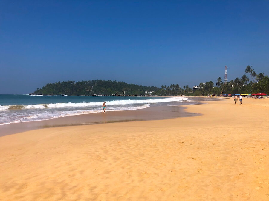 The long golden sweep of Mirissa Beach