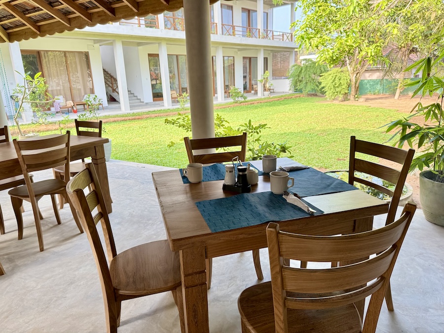 Breakfast tables set under the open-air garden pavilion