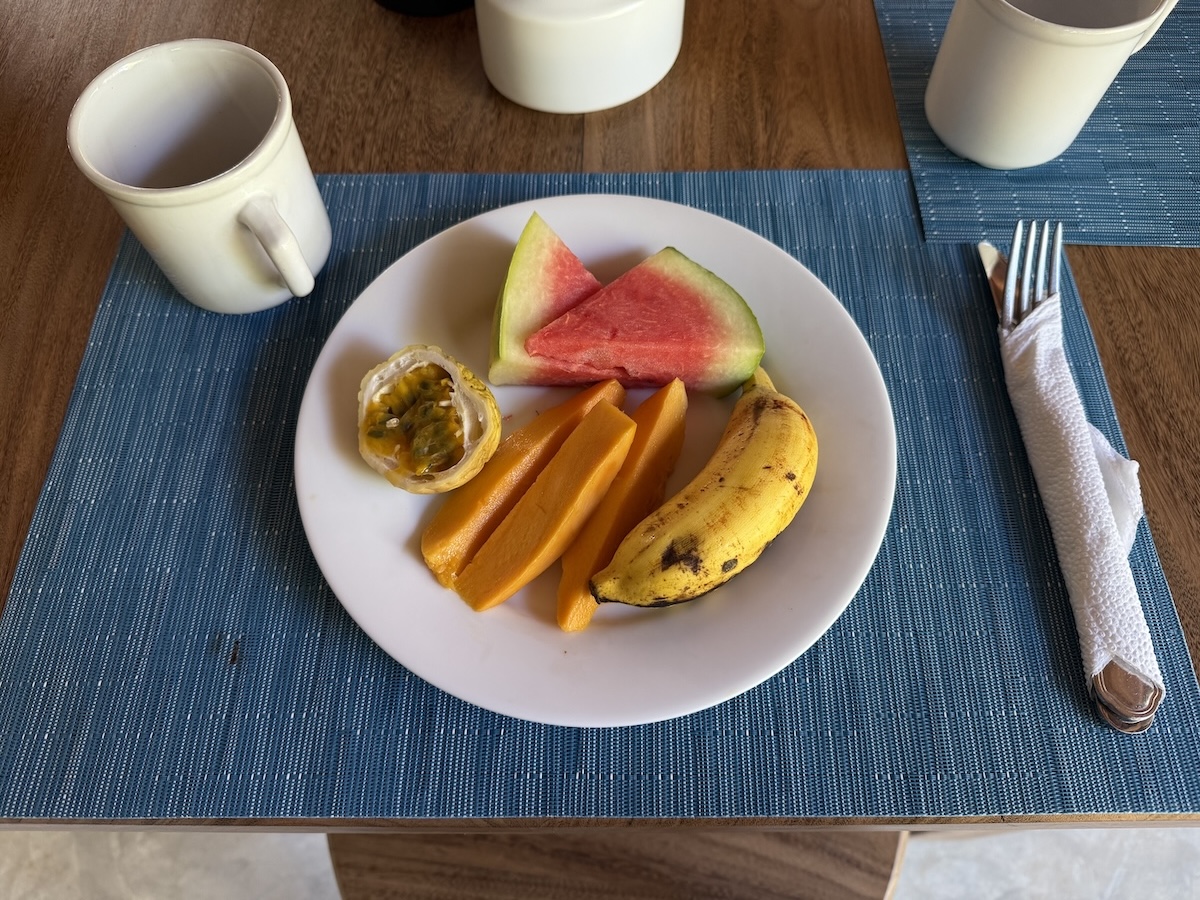 A plate of tropical fruit and pancakes served for breakfast