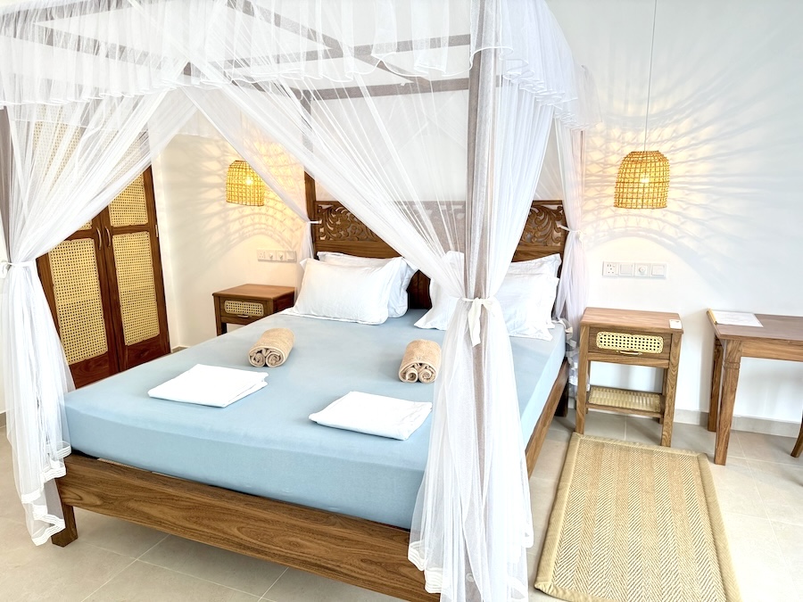 Bright ground-floor room with a double bed and doors opening to the garden